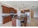 Well-equipped kitchen with dark wood cabinets, granite countertops, stainless steel appliances, and an island with bar seating at 7743 Ridgelake Cir, Bradenton, FL 34203
