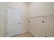 Functional laundry room with tile flooring, a door, and a wire shelf at 7743 Ridgelake Cir, Bradenton, FL 34203