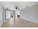 Open-concept living room with tile floors, sliding doors to a patio, and views of the kitchen at 7743 Ridgelake Cir, Bradenton, FL 34203