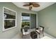 Relaxing screened-in lanai with ceiling fan, outdoor furniture and beautiful lake view at 7743 Ridgelake Cir, Bradenton, FL 34203