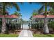 View of the community pool area through a gated entrance with covered pavilions in the background at 7743 Ridgelake Cir, Bradenton, FL 34203