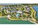 Aerial view of the community clubhouse, pool, tennis courts and lake at 8033 Grande Shores Dr, Sarasota, FL 34240