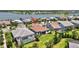 Backyard view of house with screened-in pool, lush grass, and serene waterfront location at 8033 Grande Shores Dr, Sarasota, FL 34240