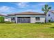 This backyard features a well maintained lawn and view of the rear of the home at 8033 Grande Shores Dr, Sarasota, FL 34240