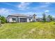 This backyard features a well maintained lawn and a view of the rear of the home at 8033 Grande Shores Dr, Sarasota, FL 34240