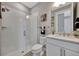 Bright bathroom featuring a walk-in shower with glass and a quartz vanity at 8033 Grande Shores Dr, Sarasota, FL 34240