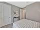 This bedroom features neutral walls, an open doorway and a bed with a striped blanket and modern decor at 8033 Grande Shores Dr, Sarasota, FL 34240