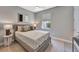 This bedroom features a window, a ceiling fan, neutral walls and a bed with patterned pillows at 8033 Grande Shores Dr, Sarasota, FL 34240