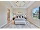 Comfortable bedroom with tray ceilings, natural light, and stylish decor at 8033 Grande Shores Dr, Sarasota, FL 34240