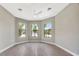 An empty room featuring 3 large windows and light gray walls at 8033 Grande Shores Dr, Sarasota, FL 34240