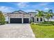 Desirable home featuring a stone facade, a two-car garage, and well-maintained landscaping at 8033 Grande Shores Dr, Sarasota, FL 34240
