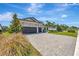 Desirable home featuring a stone facade, a two-car garage, and well-maintained landscaping at 8033 Grande Shores Dr, Sarasota, FL 34240
