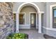 Close up of the front entrance with decorative glass door, columns and professional landscaping at 8033 Grande Shores Dr, Sarasota, FL 34240