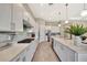 Bright kitchen featuring white cabinets, stainless steel appliances, gas cooktop and a decorative backsplash at 8033 Grande Shores Dr, Sarasota, FL 34240