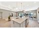 Open-concept kitchen featuring a large island, modern appliances, and a seamless flow to the living area at 8033 Grande Shores Dr, Sarasota, FL 34240