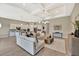 Bright, open-concept living room featuring a large sofa, modern decor, and open access to other parts of the home at 8033 Grande Shores Dr, Sarasota, FL 34240