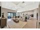 Bright, open-concept living room featuring a modern kitchen, dining area, and comfortable seating with light, neutral decor at 8033 Grande Shores Dr, Sarasota, FL 34240