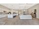 Open-concept living space with a modern kitchen, large island with seating, and a comfortable living area in neutral tones at 8033 Grande Shores Dr, Sarasota, FL 34240