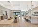 Open-concept living room and kitchen with modern light fixtures and an expansive island at 8033 Grande Shores Dr, Sarasota, FL 34240