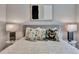 This main bedroom features a bed with a striped blanket and decorative pillows and contemporary bedside tables at 8033 Grande Shores Dr, Sarasota, FL 34240