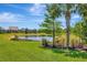 Picturesque view of a tranquil pond surrounded by lush greenery, palm trees, and meticulously manicured landscaping at 8033 Grande Shores Dr, Sarasota, FL 34240