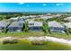 An aerial view showcasing lakefront properties, each featuring a screened lanai with a private pool at 8059 Waterbend Trl, Sarasota, FL 34240