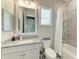 Well-lit bathroom featuring modern vanity, tiled shower, and neutral color palette at 8059 Waterbend Trl, Sarasota, FL 34240