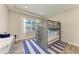 bedroom featuring built-in bunk beds and neutral colored striped carpet at 8059 Waterbend Trl, Sarasota, FL 34240