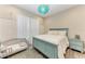 Cozy bedroom with a blue bed frame and matching furniture, complemented by soft, sheer curtains at 8059 Waterbend Trl, Sarasota, FL 34240
