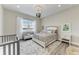 Cozy bedroom with a water view, decorative chandelier and wood flooring at 8059 Waterbend Trl, Sarasota, FL 34240