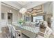 Elegant dining room with chandelier, long table, and seamless transition to living area with water view at 8059 Waterbend Trl, Sarasota, FL 34240