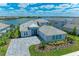 Stunning waterfront home boasts lush landscaping, a paved driveway, and a three-car garage at 8059 Waterbend Trl, Sarasota, FL 34240