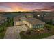 Waterfront home boasts professional landscaping, a paved driveway, and a three-car garage at 8059 Waterbend Trl, Sarasota, FL 34240