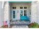 Inviting front entryway features stone pillars, a blue door, and a comfortable bench at 8059 Waterbend Trl, Sarasota, FL 34240
