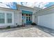 Charming front entrance with stone accents, a bench, and covered porch at 8059 Waterbend Trl, Sarasota, FL 34240