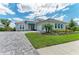 Well-maintained home with a three-car garage, stylish shutters, and a manicured lawn at 8059 Waterbend Trl, Sarasota, FL 34240