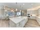 Spacious kitchen island with seating area and views of living area and stainless steel appliances at 8059 Waterbend Trl, Sarasota, FL 34240