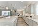 Kitchen with center island, stainless appliances and view of the living room with outdoor access at 8059 Waterbend Trl, Sarasota, FL 34240