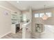 Upstairs kitchenette featuring a sink, microwave, cabinets, and a beverage cooler at 8059 Waterbend Trl, Sarasota, FL 34240