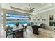 Covered outdoor living space featuring a dining area and comfortable seating with water view at 8059 Waterbend Trl, Sarasota, FL 34240