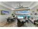 Outdoor living space with covered dining and seating, overlooking the pool and lake at 8059 Waterbend Trl, Sarasota, FL 34240
