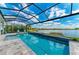 Sparkling pool with screened enclosure, lake views and lush landscaping at 8059 Waterbend Trl, Sarasota, FL 34240