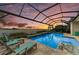 Enjoy scenic lake views from this private screened-in pool with waterfall feature at 8059 Waterbend Trl, Sarasota, FL 34240