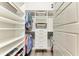 Spacious walk-in closet with custom shelving, baskets and drawers to maximize storage at 8059 Waterbend Trl, Sarasota, FL 34240