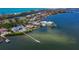 Expansive waterfront property with a private dock, lush landscaping, and stunning views of the bay and nearby islands at 8155 Midnight Pass Rd, Sarasota, FL 34242