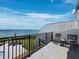 Balcony with chairs overlooking bay with a dock, boat, and outdoor seating at 8155 Midnight Pass Rd, Sarasota, FL 34242