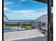 Balcony with chairs and a view of the pool and bay at 8155 Midnight Pass Rd, Sarasota, FL 34242