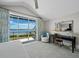 Bedroom features water views, comfortable chair and well lit desk at 8155 Midnight Pass Rd, Sarasota, FL 34242