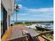 Spacious deck boasts waterfront views, lounge chairs and access to a well-manicured yard at 8155 Midnight Pass Rd, Sarasota, FL 34242