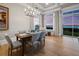 Stylish dining room with seating for six, complemented by natural light and serene water views at 8155 Midnight Pass Rd, Sarasota, FL 34242